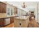 Bright kitchen features granite countertops, stainless steel appliances, custom cabinets, and a large center island at 2323 Carinth Way, Henderson, NV 89074