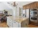 Spacious kitchen features granite counters, a large center island, stainless steel appliances and custom cabinetry at 2323 Carinth Way, Henderson, NV 89074