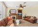 Cozy living room with fireplace, custom built-ins, and comfortable sofas at 2323 Carinth Way, Henderson, NV 89074