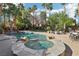 Beautiful backyard pool and spa surrounded by lush landscaping and palm trees at 2323 Carinth Way, Henderson, NV 89074