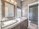 Modern bathroom with double vanity sinks, quartz countertops and tiled walls at 251 S Green Valley Pkwy # 3412, Henderson, NV 89012