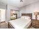 Comfortable bedroom featuring a wood-framed bed, nightstand, and mirrored closet doors at 251 S Green Valley Pkwy # 3412, Henderson, NV 89012