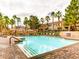 Large community pool with palm trees, lounge chairs and ample space to relax and enjoy the outdoors at 251 S Green Valley Pkwy # 3412, Henderson, NV 89012