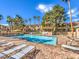 Resort-style community pool with lounge chairs and palm trees, perfect for relaxing under the sun at 251 S Green Valley Pkwy # 3412, Henderson, NV 89012