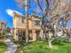 Charming two-story exterior of the property with well-maintained lawn and mature trees on a sunny day at 251 S Green Valley Pkwy # 3412, Henderson, NV 89012