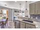 Bright kitchen features an island with granite counters, stainless appliances, and adjacent dining area at 251 S Green Valley Pkwy # 3412, Henderson, NV 89012
