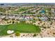 Wide aerial view featuring desert landscaping, a neighborhood, and a golf course in the distance at 2623 Turtle Head Peak Dr, Las Vegas, NV 89135
