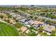 High aerial view features desert landscape, a golf course, and luxury homes with swimming pools at 2623 Turtle Head Peak Dr, Las Vegas, NV 89135