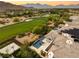 Stunning aerial showcasing a home with a pool and golf course views set against a mountain backdrop at 2623 Turtle Head Peak Dr, Las Vegas, NV 89135