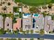 Aerial view showcases a home's backyard pool and landscaping, and an adjacent neighborhood at 2623 Turtle Head Peak Dr, Las Vegas, NV 89135