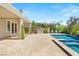 Spacious backyard featuring a refreshing pool, spa, covered patio, and outdoor kitchen at 2623 Turtle Head Peak Dr, Las Vegas, NV 89135