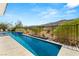 Long backyard pool with desert landscape and mountains in the distance providing privacy at 2623 Turtle Head Peak Dr, Las Vegas, NV 89135
