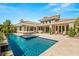 Beautiful backyard with a sparkling pool, spa, and patio, ideal for outdoor entertaining and relaxation at 2623 Turtle Head Peak Dr, Las Vegas, NV 89135