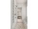 Walk-in shower with pebbled floor and glass block window next to the vanity in the bathroom at 2623 Turtle Head Peak Dr, Las Vegas, NV 89135