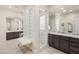 Bathroom featuring dual vanities, a glass block window and a large, mirrored walk-in shower at 2623 Turtle Head Peak Dr, Las Vegas, NV 89135