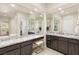 Bright bathroom with dual vanities, granite countertops, and a walk-in shower with glass block window at 2623 Turtle Head Peak Dr, Las Vegas, NV 89135