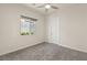 Comfortable bedroom with soft carpet, natural light, and a ceiling fan at 2623 Turtle Head Peak Dr, Las Vegas, NV 89135