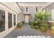 Elegant home entrance with a paver walkway, lush greenery, and a charming courtyard, creating a welcoming approach at 2623 Turtle Head Peak Dr, Las Vegas, NV 89135