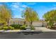 Charming single-story home with a well-manicured lawn, mature trees, and a welcoming front porch, showcasing curb appeal at 2623 Turtle Head Peak Dr, Las Vegas, NV 89135