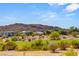 View of backyard and nearby golf course with desert landscape and mountain views on a sunny day at 2623 Turtle Head Peak Dr, Las Vegas, NV 89135