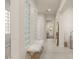 Hallway featuring glass block windows for natural light, a plush bench, and tiled floors at 2623 Turtle Head Peak Dr, Las Vegas, NV 89135