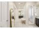 Hallway showcasing the bathroom with a glass block window, neutral color palette, and tiled flooring at 2623 Turtle Head Peak Dr, Las Vegas, NV 89135