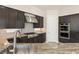 Close up of custom kitchen featuring stainless steel appliances and granite counter tops at 2623 Turtle Head Peak Dr, Las Vegas, NV 89135