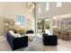 Well-lit living room featuring stylish furniture, high ceilings, and easy access to the outdoor area at 2623 Turtle Head Peak Dr, Las Vegas, NV 89135