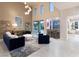 Inviting living room with tall windows, high ceilings, sleek furniture, and an adjacent bar at 2623 Turtle Head Peak Dr, Las Vegas, NV 89135