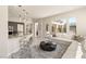 Open concept living room featuring a modern kitchen, white sectional sofa, and view of the outdoor patio at 2623 Turtle Head Peak Dr, Las Vegas, NV 89135