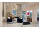 Bright living room featuring a high ceiling, modern decor, and a convenient bar area at 2623 Turtle Head Peak Dr, Las Vegas, NV 89135