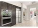 Contemporary kitchen featuring stainless steel appliances and custom pantry storage at 2623 Turtle Head Peak Dr, Las Vegas, NV 89135