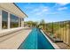 Backyard pool extends away from a home's patio, featuring desert landscaping and partial outdoor kitchen at 2623 Turtle Head Peak Dr, Las Vegas, NV 89135