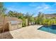 Outdoor kitchen area and pool are nestled in a backyard with desert landscaping and wrought iron fence at 2623 Turtle Head Peak Dr, Las Vegas, NV 89135