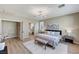 Bedroom with wood-look flooring boasts ensuite bathroom and ample natural light at 2714 Langlade Ave, Henderson, NV 89052