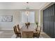 Elegant dining room with a wooden table, tufted chairs, designer lighting, and a decorative accent wall at 2714 Langlade Ave, Henderson, NV 89052