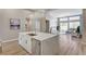 Kitchen island with marble countertops, stainless steel dishwasher, and open layout to living area at 2714 Langlade Ave, Henderson, NV 89052