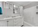 Bathroom featuring double sinks, a marble countertop, and a shower-tub combo at 3305 Palomar St, North Las Vegas, NV 89030