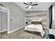 Bedroom featuring modern striped accent wall, desk space and soft carpet at 3305 Palomar St, North Las Vegas, NV 89030