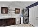 Modern kitchen boasts stainless steel appliances, white countertops, and a convenient washer/dryer for added functionality at 3305 Palomar St, North Las Vegas, NV 89030