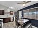Bright kitchen features modern appliances, dark cabinets, and a dining area with views from the window at 3305 Palomar St, North Las Vegas, NV 89030