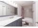 Bright bathroom featuring a modern vanity with marble countertop and a shower-tub combo at 3440 Pino Cir, Las Vegas, NV 89121