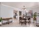 Open concept dining area with views to the kitchen and wood flooring at 3440 Pino Cir, Las Vegas, NV 89121