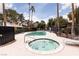 A relaxing pool and hot tub area featuring lush greenery and palm trees against a blue sky backdrop at 3440 Pino Cir, Las Vegas, NV 89121