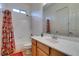 Clean bathroom with a tub-shower combo, a bright vanity, and white tile at 3801 W Hammer Ln, North Las Vegas, NV 89031