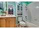 Bright bathroom with a shower-tub combination, white tile, and a wooden vanity at 3801 W Hammer Ln, North Las Vegas, NV 89031