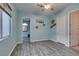 Bright bedroom featuring wood-look floors, a ceiling fan, and three entryways at 3801 W Hammer Ln, North Las Vegas, NV 89031