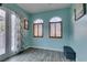 Bedroom with light blue walls, shuttered windows, and access to a patio at 3801 W Hammer Ln, North Las Vegas, NV 89031