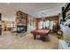 Open game room with a pool table, fireplace, and views of the living and dining areas at 3801 W Hammer Ln, North Las Vegas, NV 89031