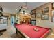 Stylish game room with a pool table and custom lighting fixture, perfect for recreation and relaxation at 3801 W Hammer Ln, North Las Vegas, NV 89031